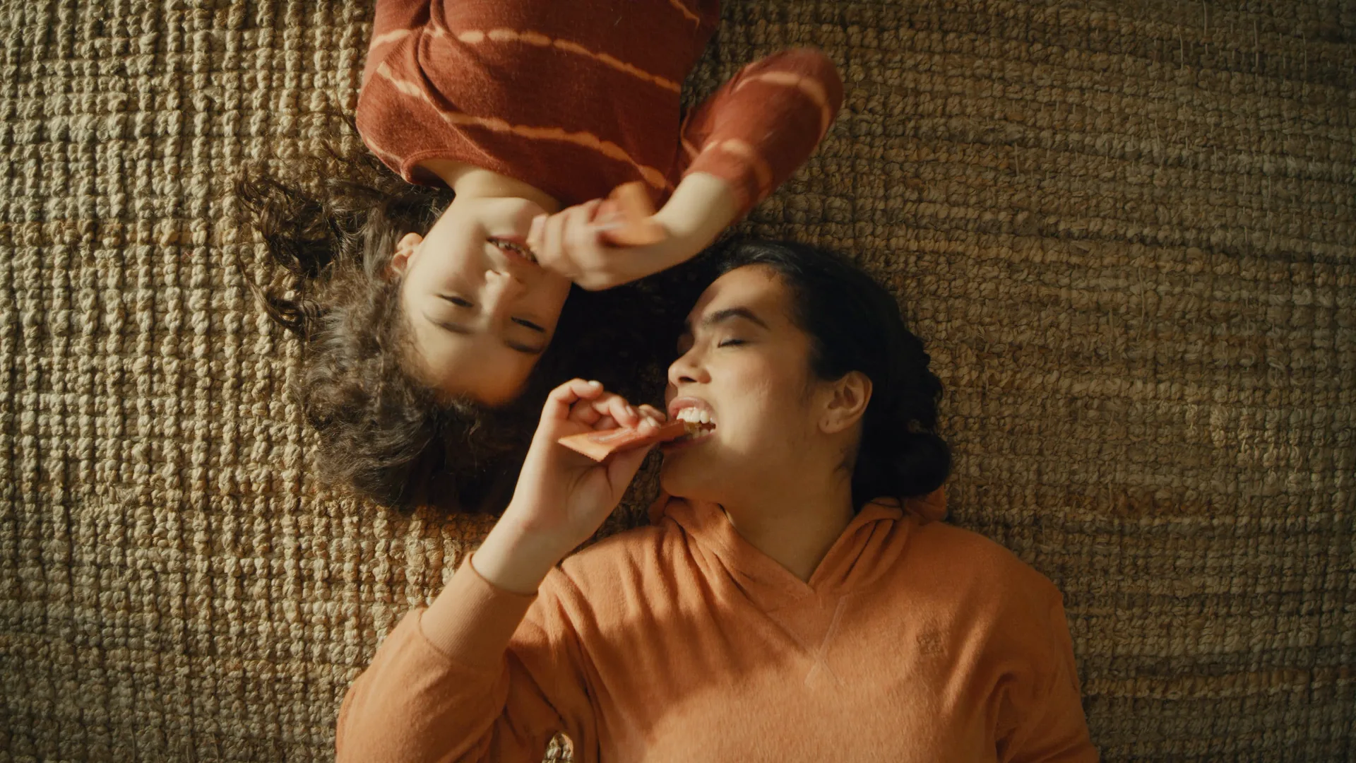 Two women lying on the floor, laughing