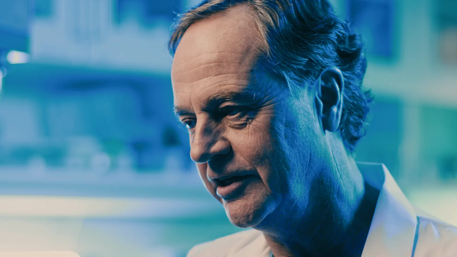 Scientist in a blue-lit lab