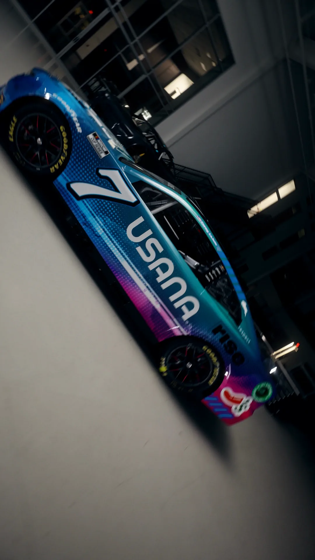 Overhead of the car turning across the shop floor