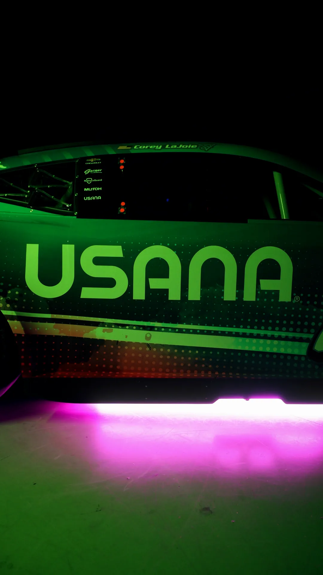 USANA lettering on the door under green and pink light