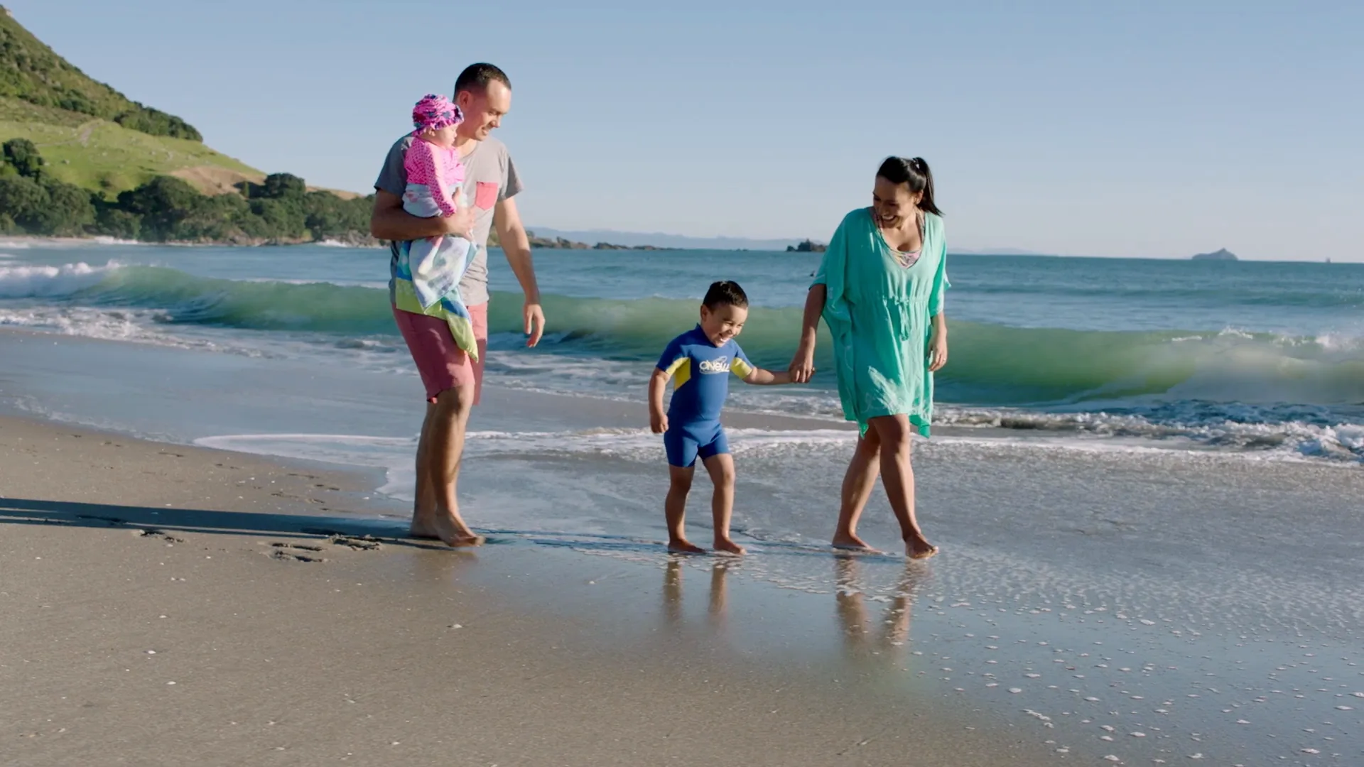 A family walking along the shoreline